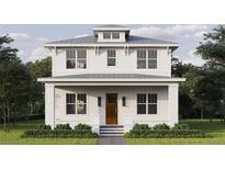 Charming two-story home featuring white wood siding and a welcoming front porch at 2910 11Th N St, St Petersburg, FL 33704