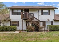 Charming two-story home with wooden staircase and well-maintained lawn at 4945 91St N Ave # 30, Pinellas Park, FL 33782