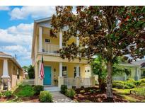 Charming two-story home with a colorful front door, columns, and nicely landscaped front yard at 5410 River Sound Ter, Bradenton, FL 34208