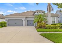 Charming single Gathering home with a three car garage and lush tropical landscaping at 7114 Bowspirit Pl, Apollo Beach, FL 33572