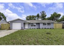Charming single-story home with a well-manicured lawn and attached one-car garage at 7625 Marechal Ave, Port Richey, FL 34668