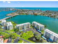 Stunning aerial view of waterfront condos with lush landscaping and beautiful bay views at 7892 Sailboat Key S Blvd # 408, South Pasadena, FL 33707