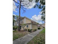 Inviting view of a two-story condo building with well-maintained landscaping and sidewalks at 8300 Bardmoor Blvd # 110, Seminole, FL 33777