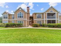 Inviting two-story condo with well-maintained landscaping and a lush green lawn at 9481 Highland Oak Dr # 212, Tampa, FL 33647