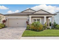 Charming single-Gathering home with a two-car garage, paver driveway, and meticulously maintained landscaping at 12451 Nouveau Ave, Spring Hill, FL 34610