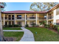 Inviting two-story condo complex with well-maintained landscaping and a tile roof at 1712 Hammock Pine Blvd # 1712, Clearwater, FL 33761