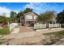 Charming two-story home with classic American architectural design, landscaped front yard, and welcoming white picket fence at 4106 N Central Ave, Tampa, FL 33603