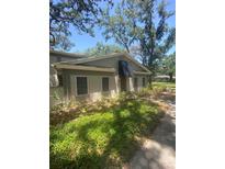 Charming single-story home with a neutral color scheme, awning, and mature landscaping for added privacy at 6214 Dewdrop Way # 621, Temple Terrace, FL 33617