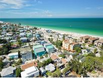 Stunning aerial view of a coastal neighborhood with beautiful beachfront homes near the ocean at 100 94Th Ave, Treasure Island, FL 33706