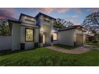 Modern home featuring a well-manicured lawn, eye-catching facade and neutral tones at 1213 E Lemon St, Tarpon Springs, FL 34689