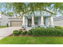 Charming single-Gathering home with a well-manicured lawn, a covered porch, and inviting curb appeal at 1237 Windy Bay Shl, Tarpon Springs, FL 34689