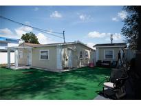 Quaint backyard features an additional building and a lush green artificial turf at 2108 W Comanche Ave, Tampa, FL 33603