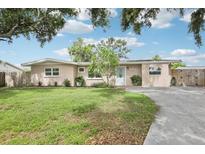 Charming single-story home with a well-maintained lawn, inviting curb appeal, and a light blue front door at 6220 Murdock Ave, Sarasota, FL 34231