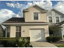 Charming two-story home featuring an attached garage and well-maintained front yard with mature landscaping at 6252 Olivedale Dr, Riverview, FL 33578
