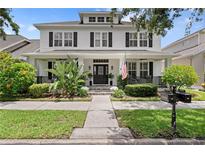 Charming two-story home with a welcoming front porch and well-manicured landscaping at 10003 Brompton Dr, Tampa, FL 33626