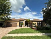 Charming single-story home with a well-manicured lawn and a three-car garage, showcasing beautiful landscaping at 1008 Arista Blvd, Valrico, FL 33594