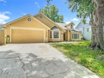 Inviting single Gathering home featuring a two-car garage and well-maintained lawn and landscaping at 10206 Evening Trail Dr, Riverview, FL 33569