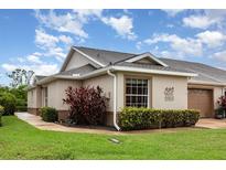 Beige home with well-maintained landscaping and trimmed hedges offers an inviting curb appeal at 1626 Terra Ceia Bay Cir # 6, Palmetto, FL 34221