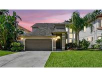 Charming two-story home featuring an attached two-car garage and a well-manicured front lawn at 3304 W Harbor View Ave, Tampa, FL 33611