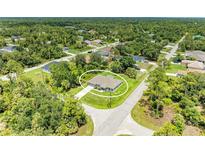 A charming single-story home surrounded by lush trees and greenery in a quiet neighborhood at 3682 Johnstown St, North Port, FL 34288