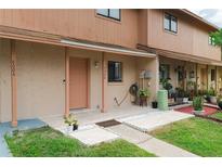 Charming townhome featuring a cozy porch and well-maintained landscaping at 4008 Pine Limb Ct, Tampa, FL 33614