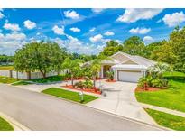 Stunning single-Gathering home features a well-manicured lawn, lush landscaping, and an attached two-car garage at 4495 Secretariat Run, Spring Hill, FL 34609