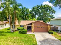 Charming single Gathering home featuring a two-car garage and inviting curb appeal at 4709 Heath Ave, Tampa, FL 33624