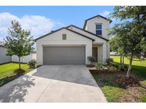 Charming two-story home featuring a spacious garage and well-maintained landscaping at 6347 Ten Acre Ct, Zephyrhills, FL 33541