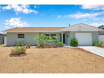 Charming single-story home featuring a manicured front yard with fresh gravel and bright green lawn at 6352 Canton S St, St Petersburg, FL 33712