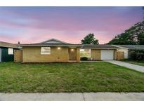 Charming single-story brick home featuring a well-maintained lawn and inviting curb appeal at 6715 Ranchwood Loop, New Port Richey, FL 34653