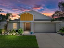 Charming single-Gathering home with a well-manicured lawn, lovely landscaping, and a two-car garage at 12931 Twin Bridges Dr, Riverview, FL 33579