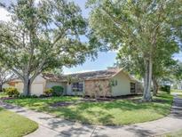 Charming single-story home with mature trees and a lush, well-maintained front yard at 1610 Sanderling Ct, Brandon, FL 33511