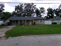 Charming single-story home with a well-maintained lawn and mature trees enhancing curb appeal at 2239 Curtis S Dr, Clearwater, FL 33764