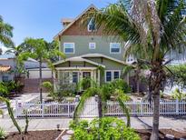 Charming two-story home with lush landscaping and a white picket fence creating curb appeal at 2504 W North A St # A, Tampa, FL 33609
