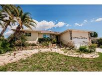 Charming single-story home with a well-kept front yard and tropical landscaping at 4434 Dewey Dr, New Port Richey, FL 34652