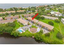 Scenic aerial view of waterfront condos, showcasing the community pool and convenient parking at 4510 Overlook Ne Dr # 224, St Petersburg, FL 33703
