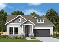 Charming single-Gathering home with a gray roof, stylish stone accents, and a dark-colored garage at 5033 Chapel Row Ave, Apollo Beach, FL 33572