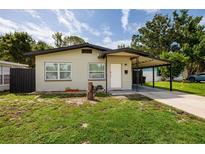 Charming single-story home with a covered carport, lush lawn, and inviting curb appeal at 5519 Kelly N Dr, St Petersburg, FL 33703