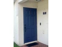A blue painted front door with a modern lock and welcome sign hanging to the side at 7719 Carriage Pointe Dr, Gibsonton, FL 33534