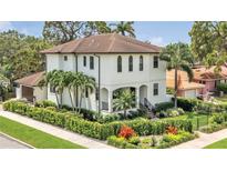 Elegant two-story home with a well-manicured lawn and tropical landscaping at 101 Bandera Ne Way, St Petersburg, FL 33704