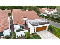 Charming home with red tile roof, brick-paved front walk, and attached garage at 11501 Cerca Del Rio Pl, Temple Terrace, FL 33617