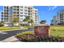 Beautiful condominium building with lush landscaping and a prominent street address sign at 125 Belleview Blvd # 503, Belleair, FL 33756