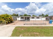 Charming single story home featuring a paver parking area and a fenced yard at 1328 Waikiki Way, Tampa, FL 33619