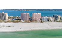 Stunning aerial view of pristine beach and luxurious beachfront highrise condos with gorgeous turquoise water views at 1340 Gulf Blvd # 16F, Clearwater, FL 33767