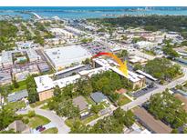 An aerial view of the condo building and surrounding area, close to the water and amenities at 2525 W Bay Dr # A46, Largo, FL 33770