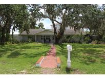 Charming single-story home with well-manicured lawn and mature trees at 358 Highland Shores Dr, Ellenton, FL 34222