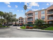 Beautiful condo building with manicured landscaping, sidewalks, and a tropical feel at 5000 Culbreath Key Way # 1-112, Tampa, FL 33611