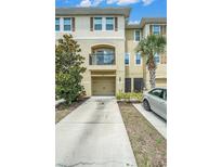 Attractive townhouse featuring a private balcony, attached garage, and manicured landscaping at 5521 Yellowfin Ct, New Port Richey, FL 34652