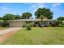 Charming single-story home featuring a manicured lawn and a classic attached one car garage at 791 66Th S Ave, St Petersburg, FL 33705