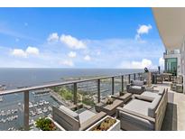 Wide balcony area with stylish seating that overlooks water and city views at 100 1St N Ave # 3905, St Petersburg, FL 33701